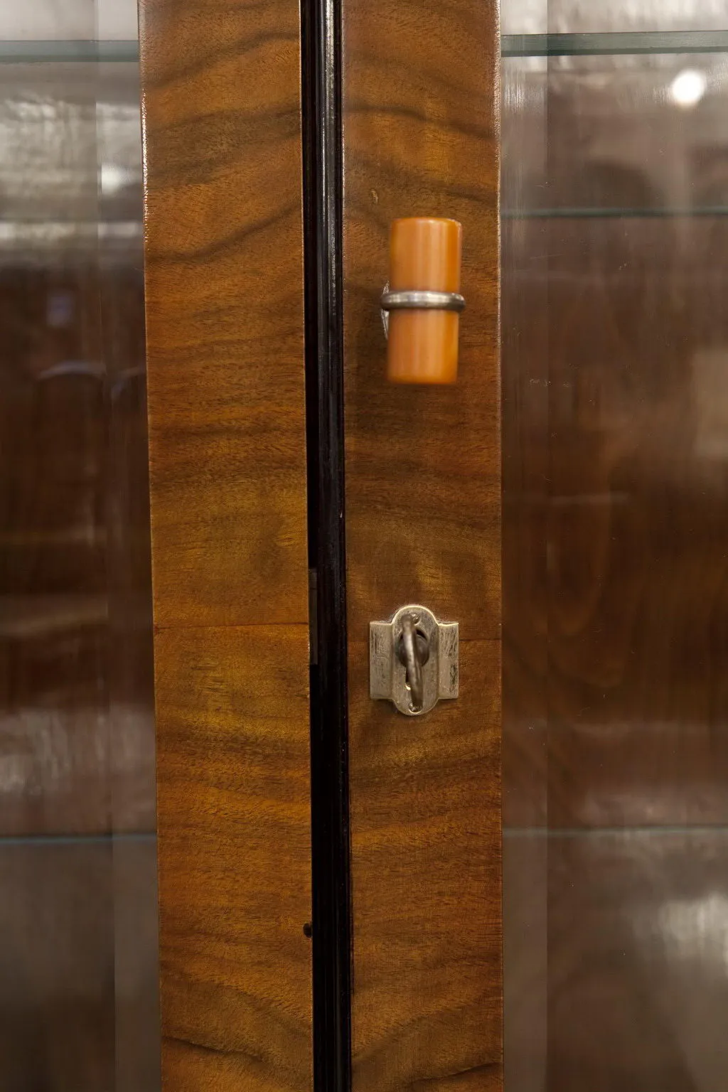 Details of an antique bookcase with a visible lock.