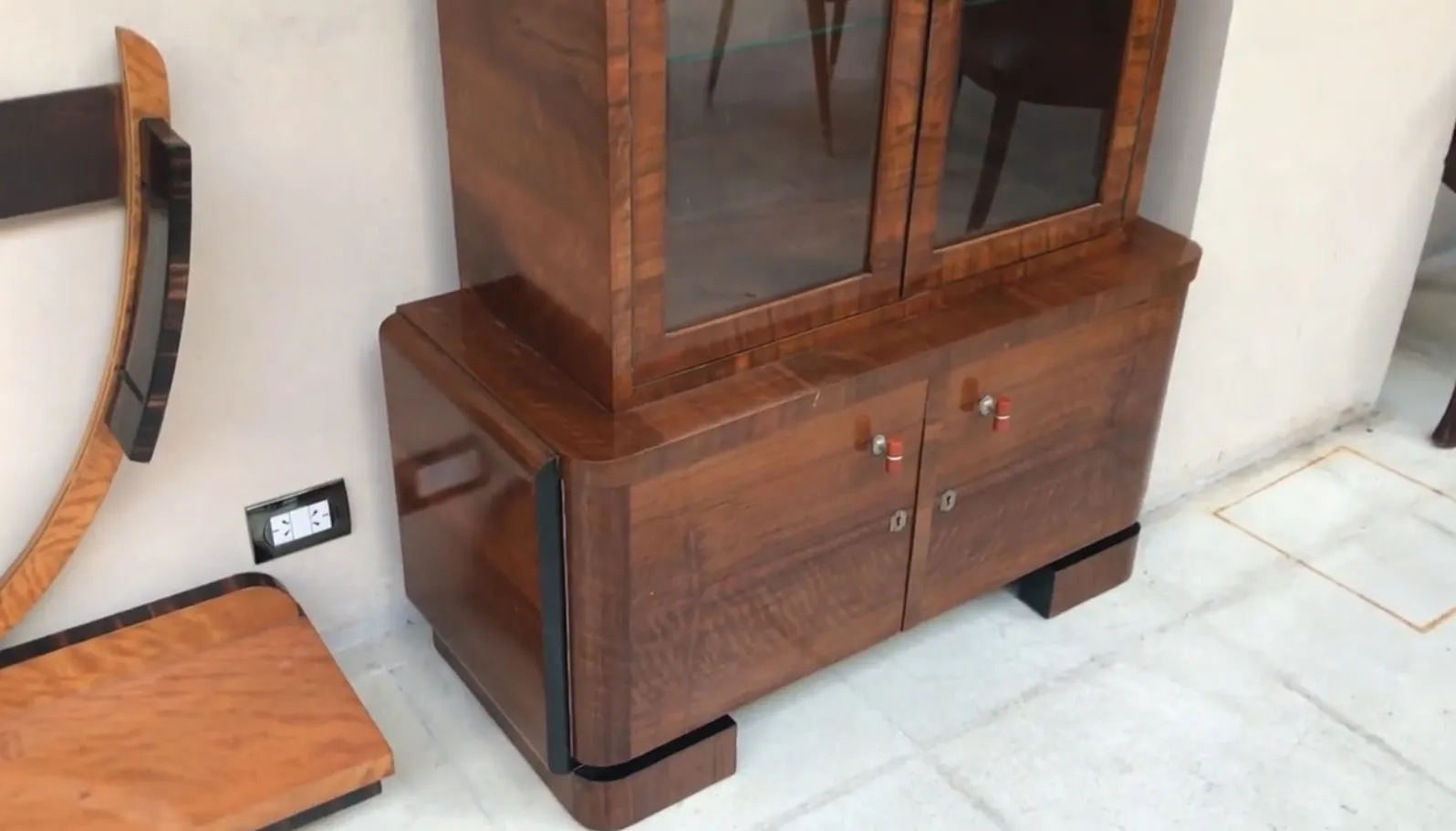 Antique bookcase with glass doors and lower storage, set in a modern environment.