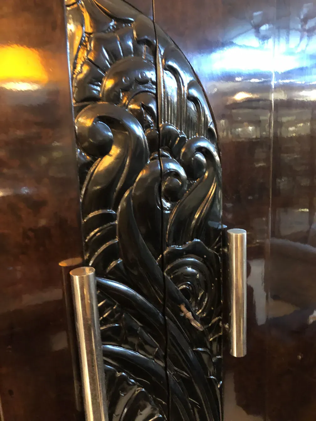 Intricate carvings on an antique bookcase with elaborate design