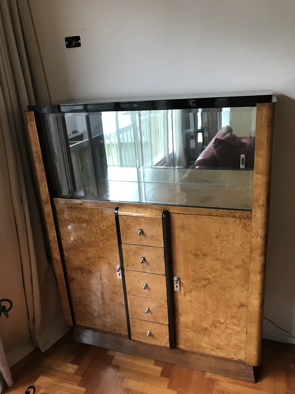 Antique bookcase with glass showcases and drawers, inviting ambiance.