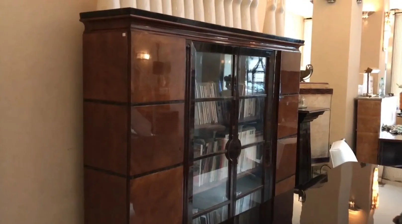 antique bookcase with glass doors and books inside