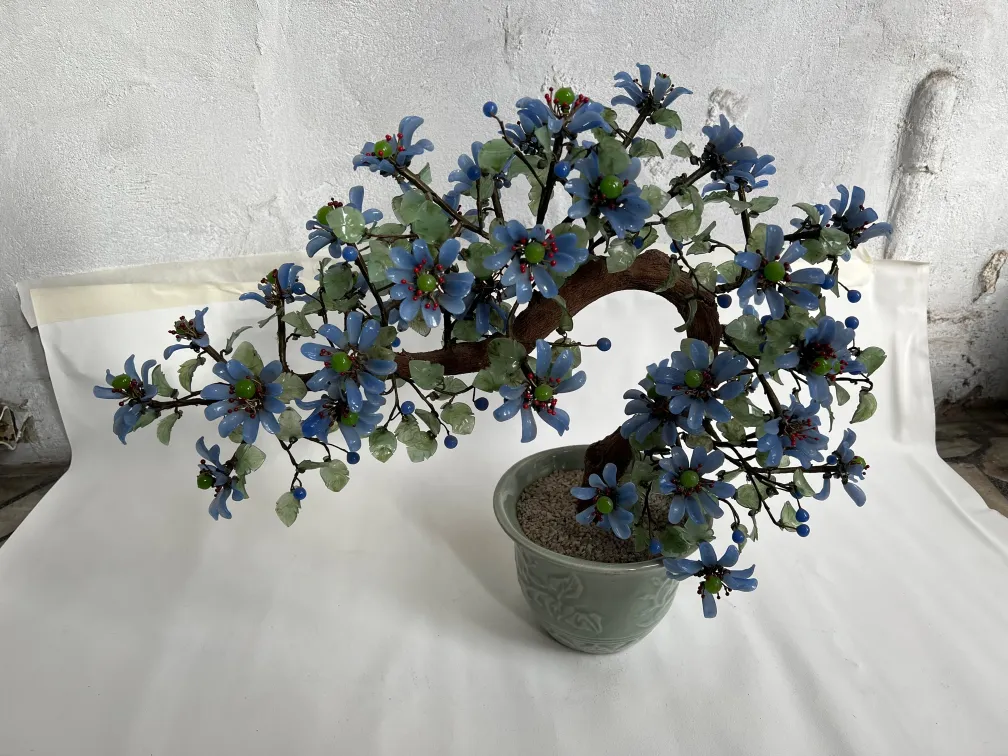 Antique decorative bonsai with blue and green flowers