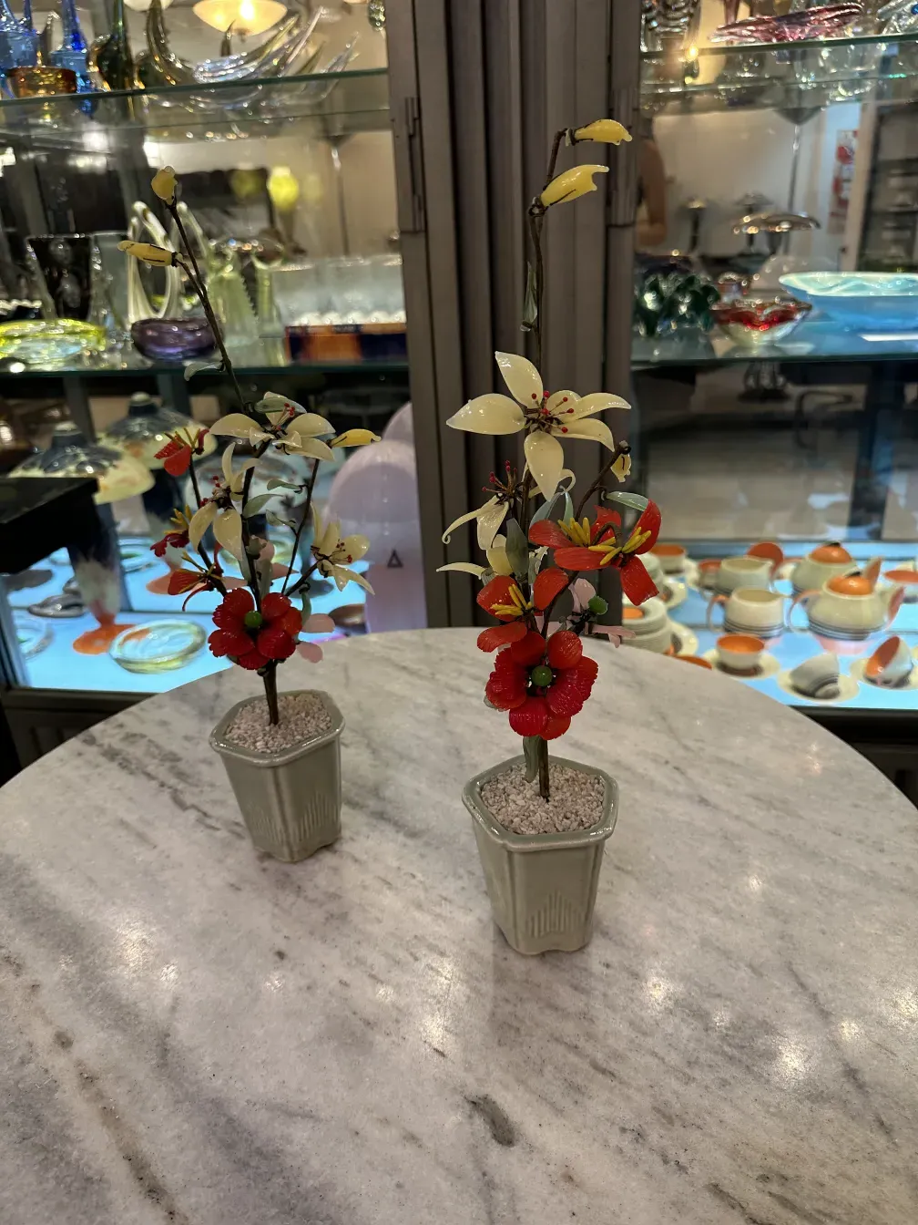 Artificial decorative antique bonsai with colorful flowers.