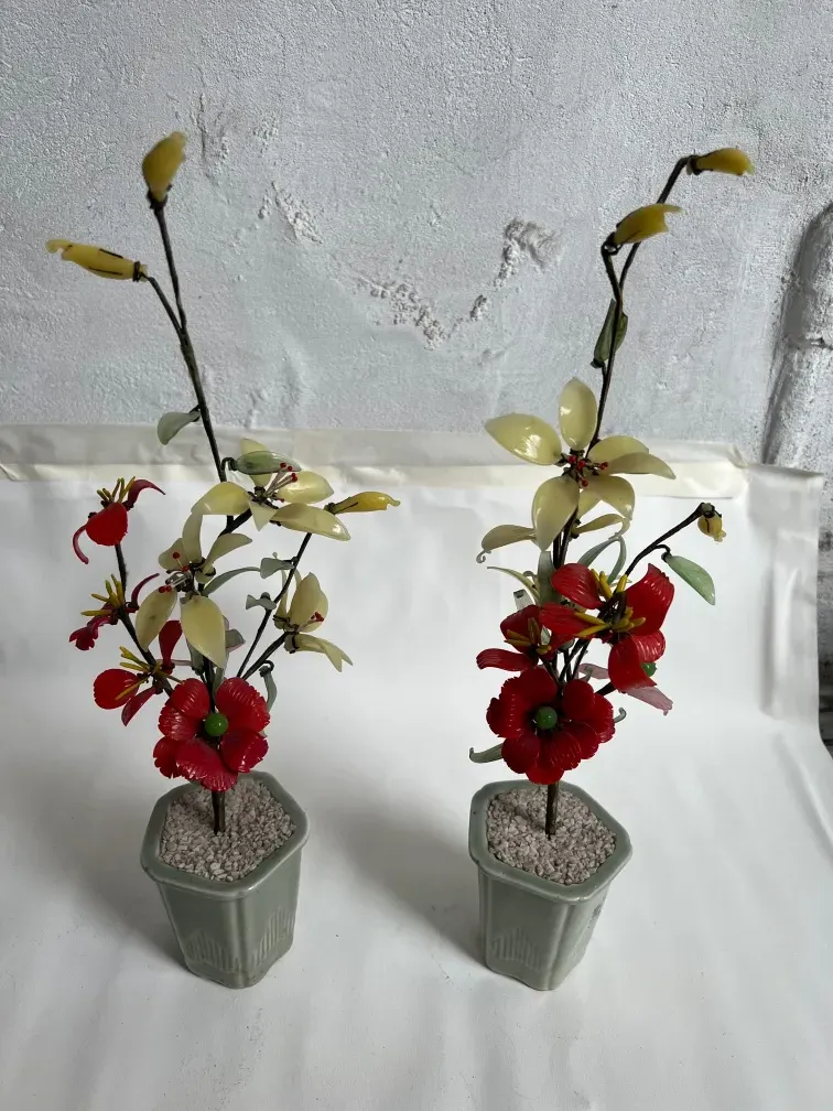 Antique bonsai with red and yellow artificial flowers