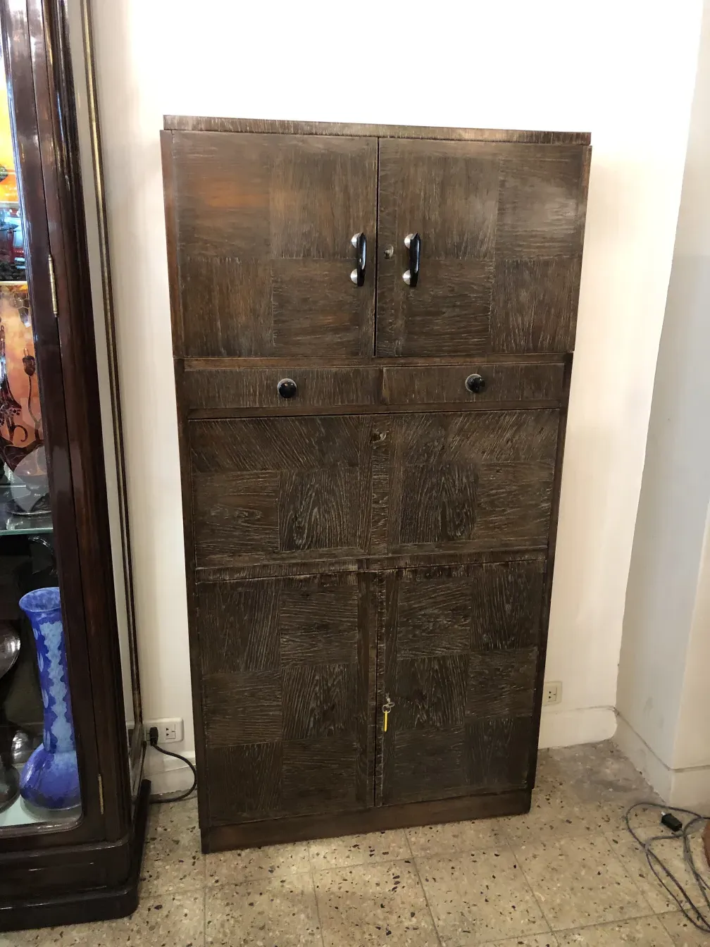 Antique bar cabinet with rustic style and doors.