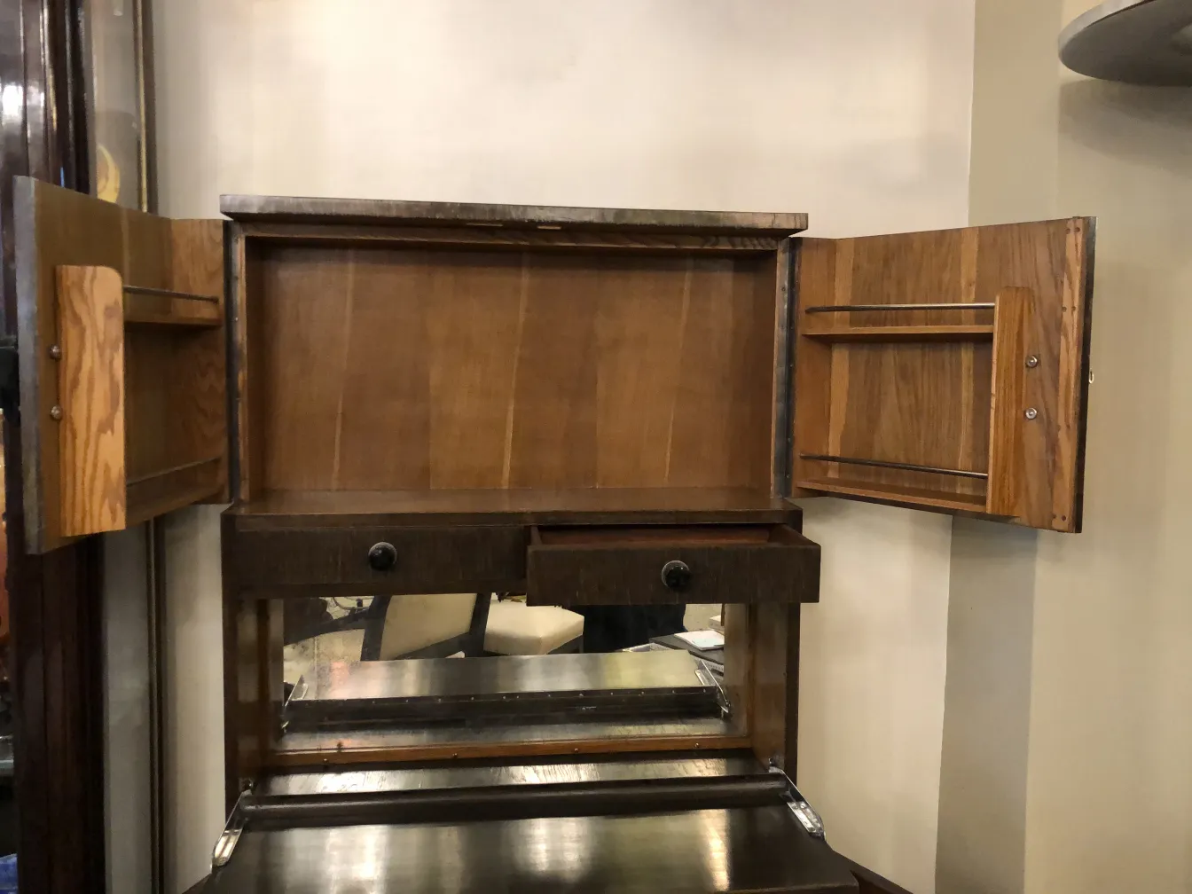 Antique bar cabinet with two doors and a drawer, elegant and functional, perfect for any setting.