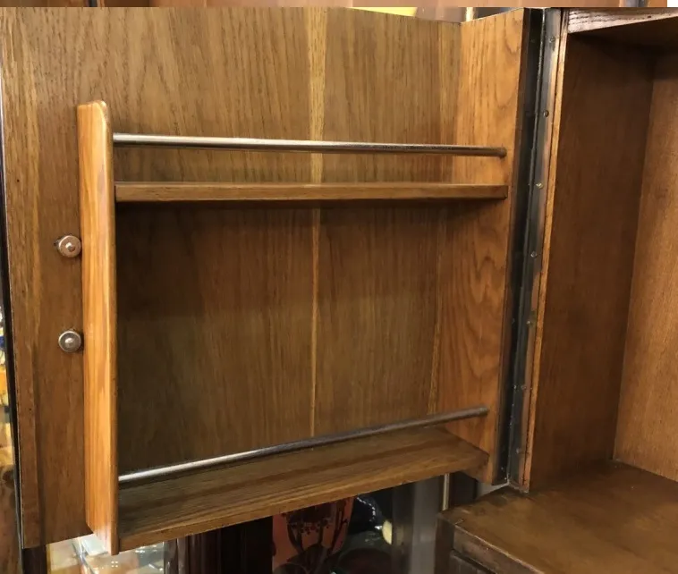Antique bar cabinet in wood featuring visible shelves
