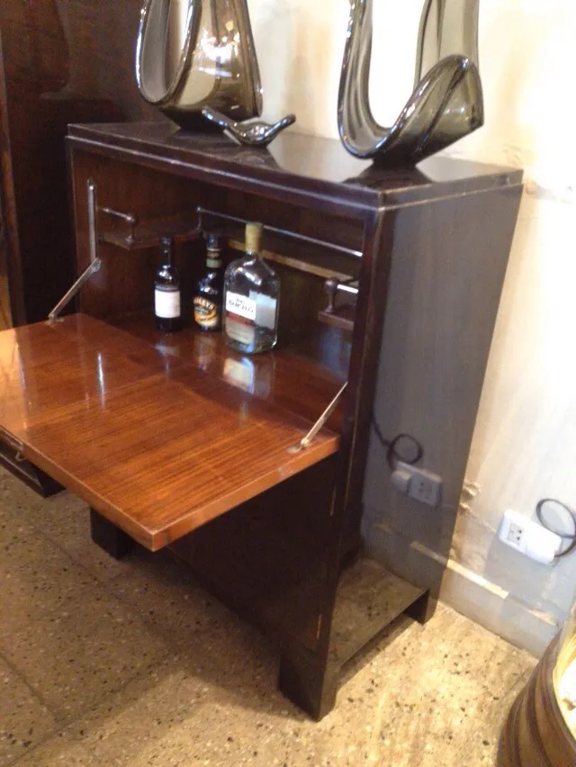 Antique bar cabinet with elegant finish and visible bottles