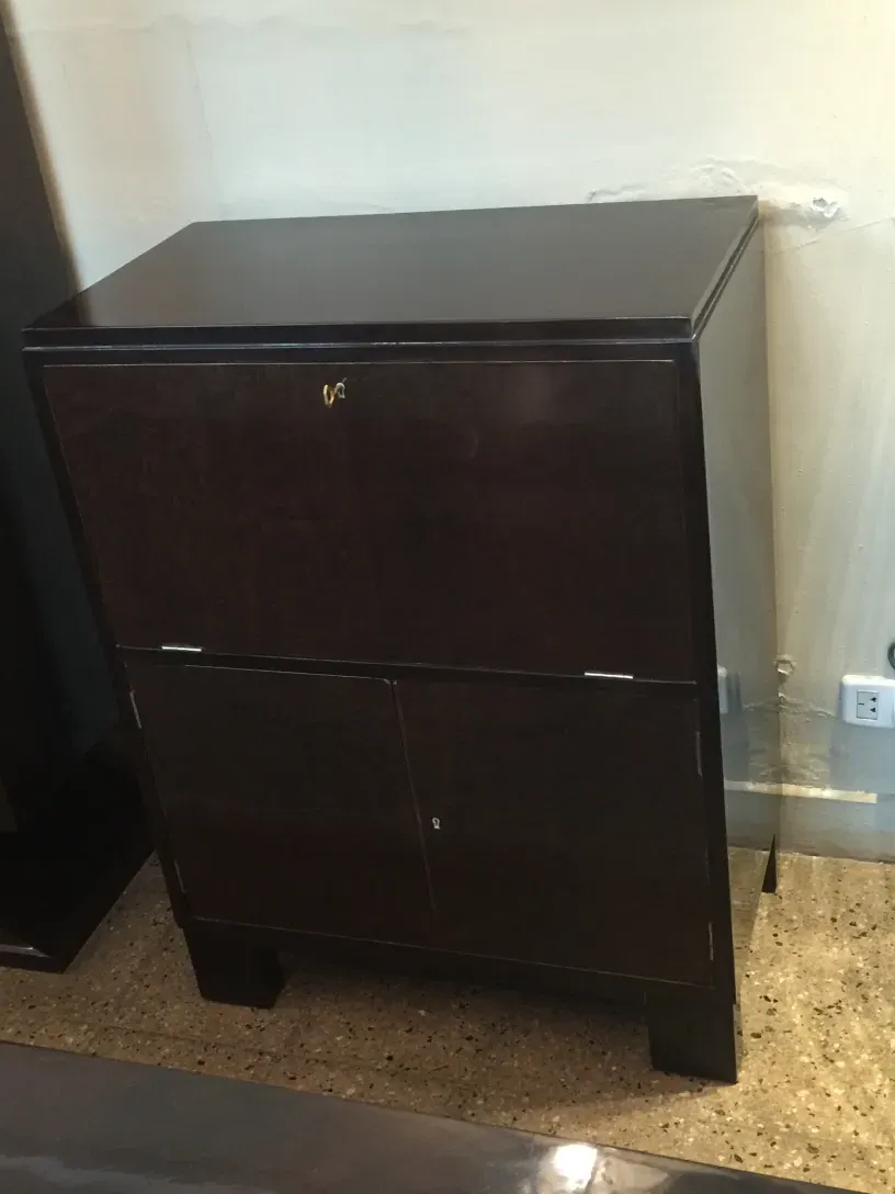 Antique bar cabinet with a dark finish and elegant details.