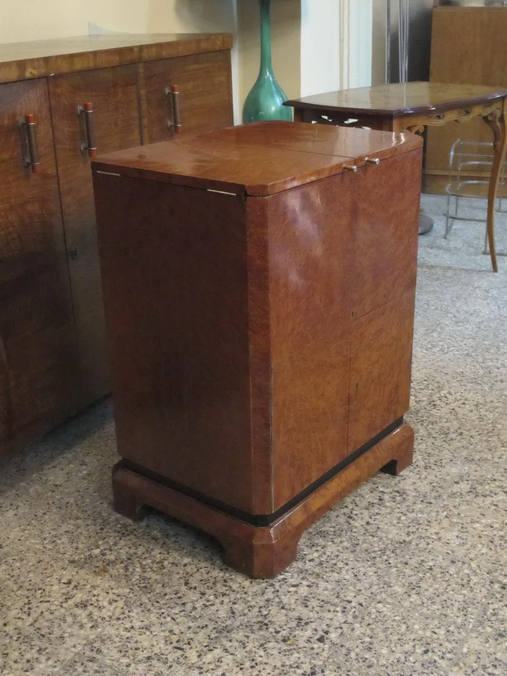 Antique bar cabinet with elegant design and shiny finish.