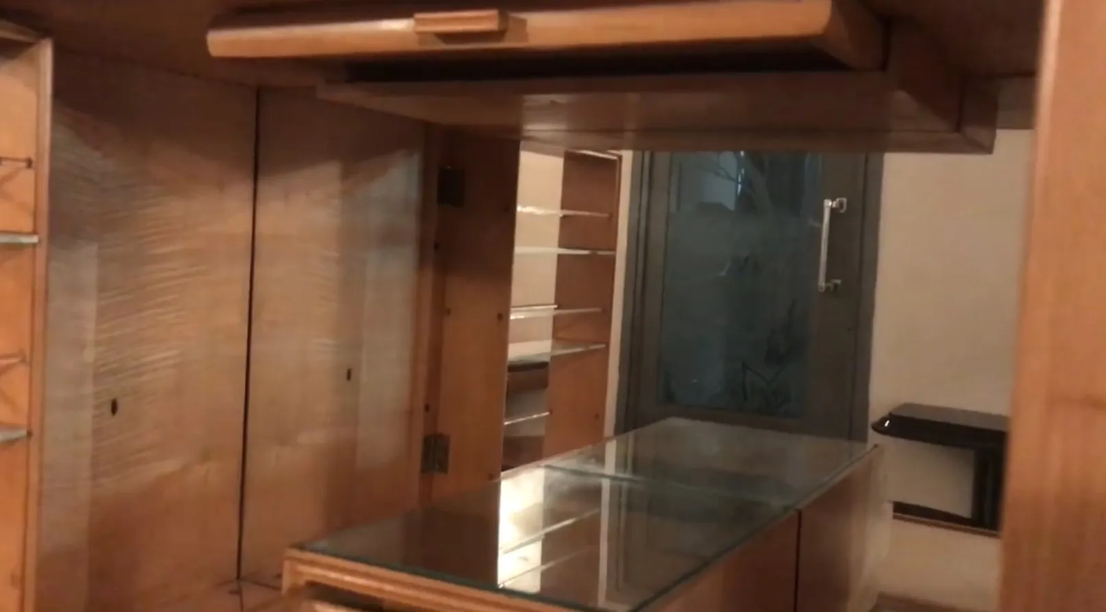Antique bar with shelves and glass background.