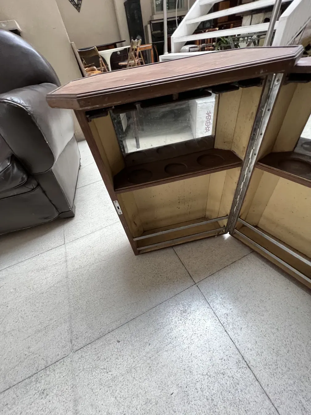 Antique bar with mirror and storage space, cozy environment.