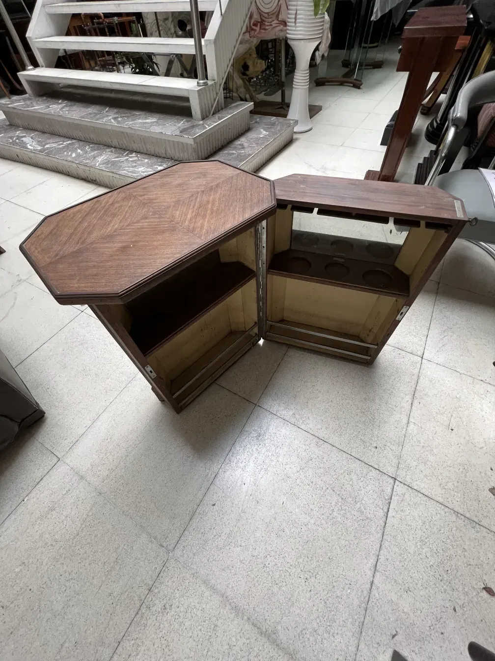 Antique bar cabinet with octagonal design, open, displaying shelves