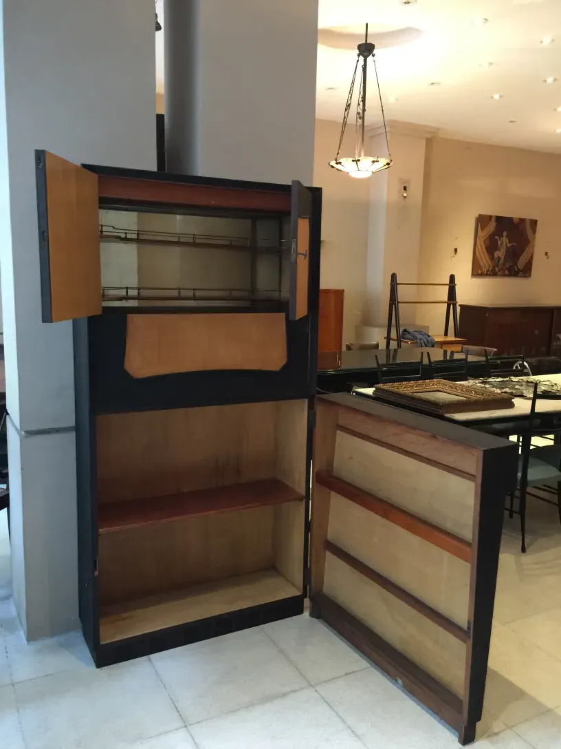 Antique bar with wooden finish and storage shelves.