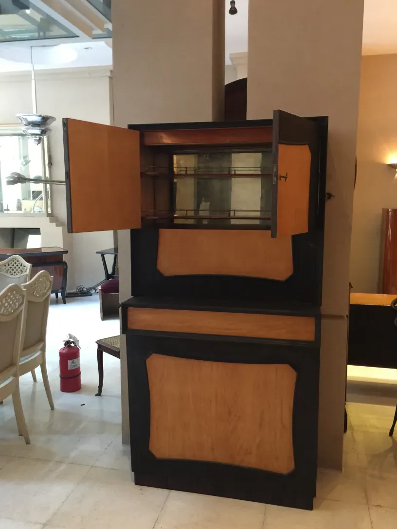 Vintage wooden bar with shelves and two doors.