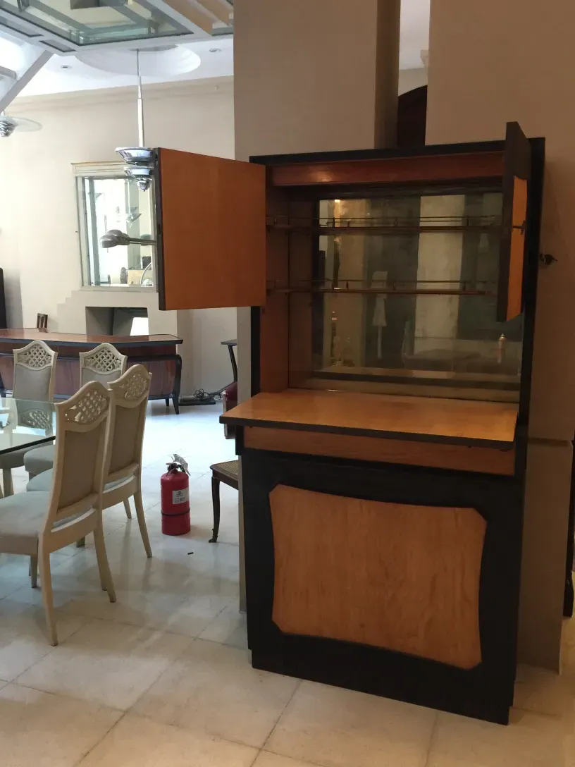 Antique bar cabinet with multiple compartments, stylish and functional, in a cozy setting