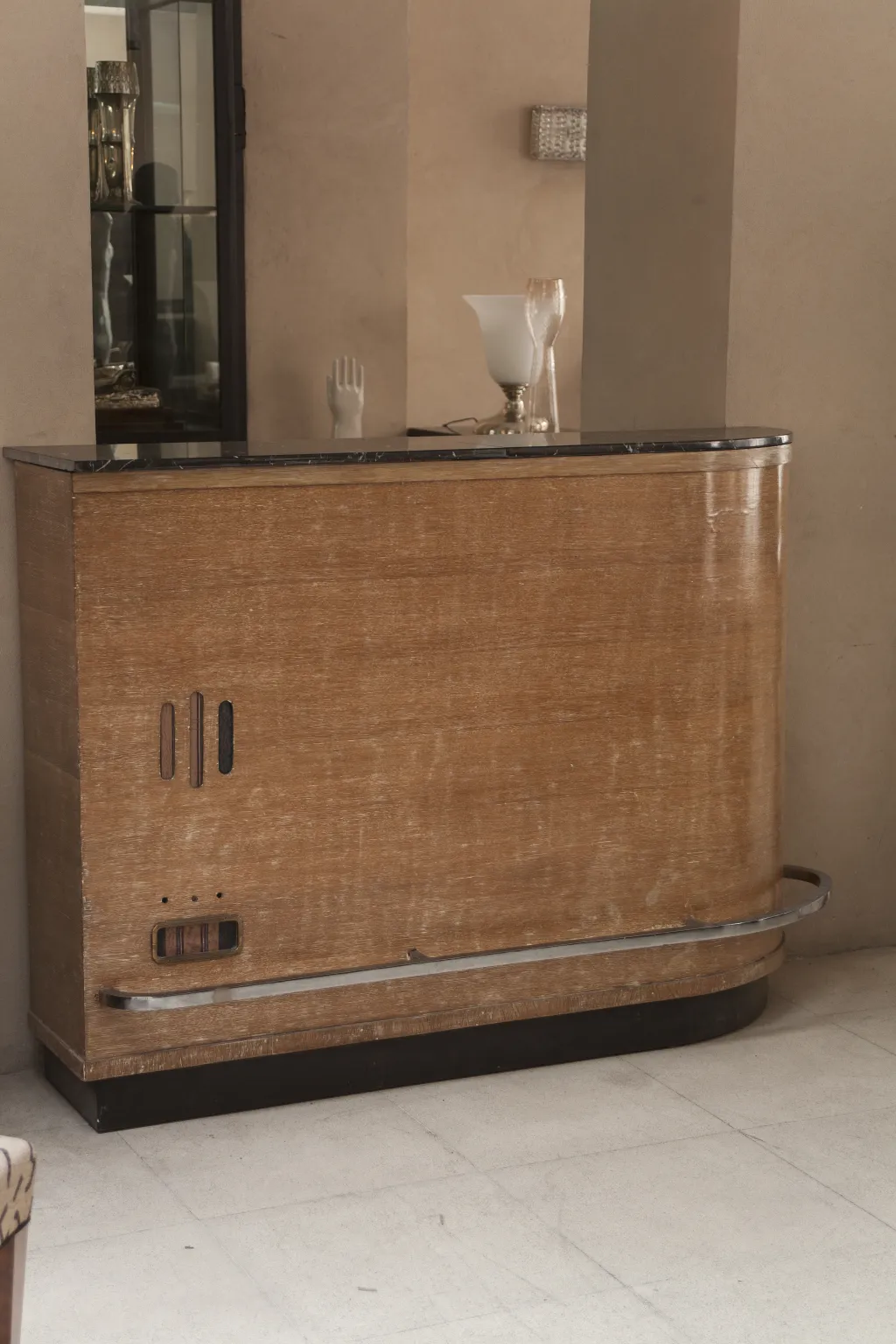 Antique bar furniture with sleek design and nearby tables.