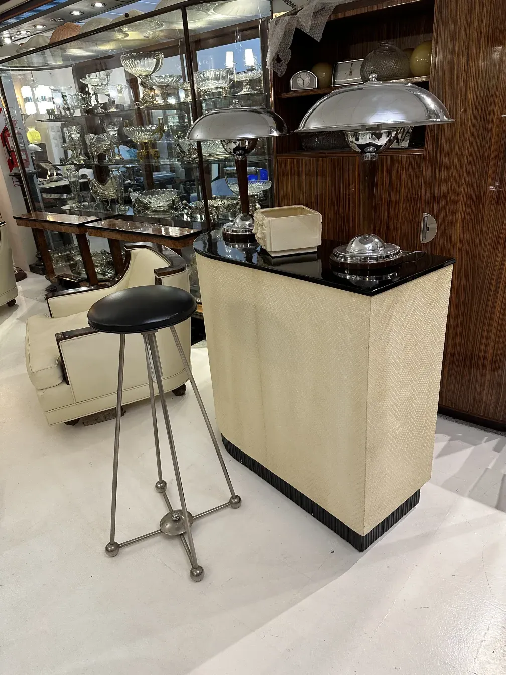 Antique bar furniture with elegant and decorative details, surrounded by glassware in a sophisticated setting.