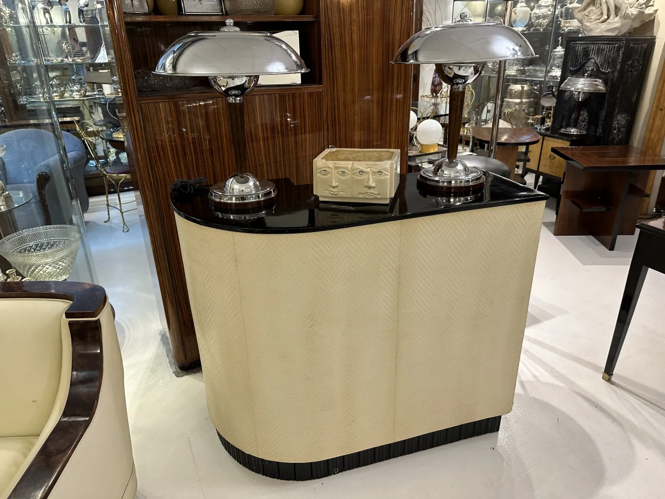 Antique bar with a black top and silver accents. Set in an elegant room.