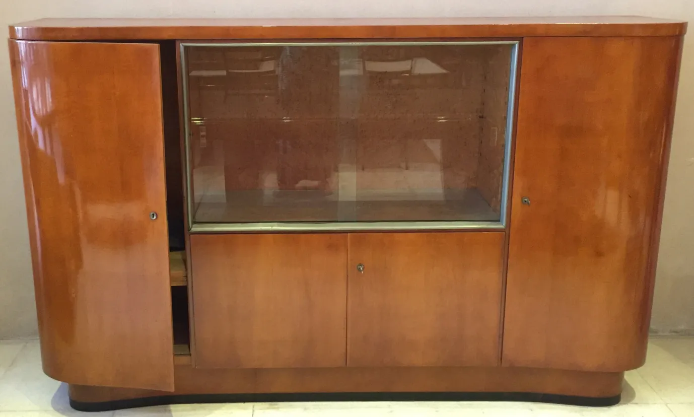 Antique bar cabinet, featuring glass doors, elegant setting.