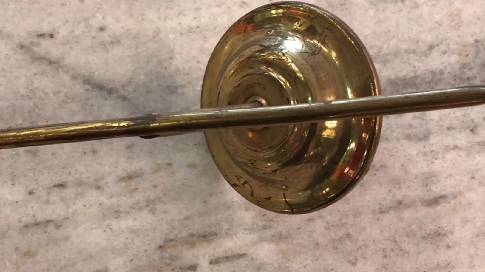 Antique pair of sconces with shiny round base, in a classic setting.