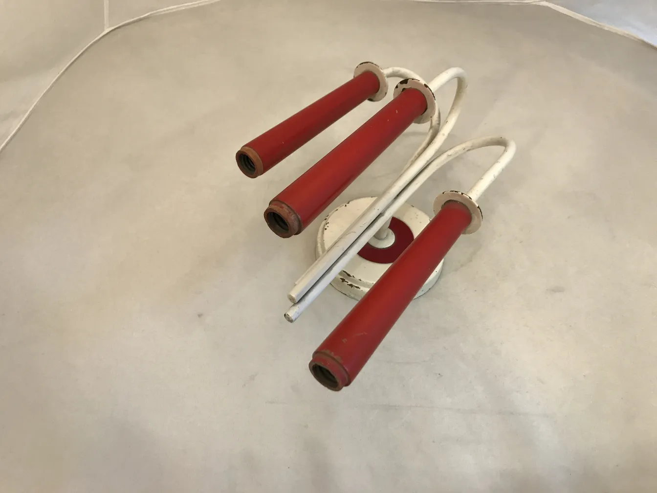 antique pair of sconces with red arms and white base, jean royère style