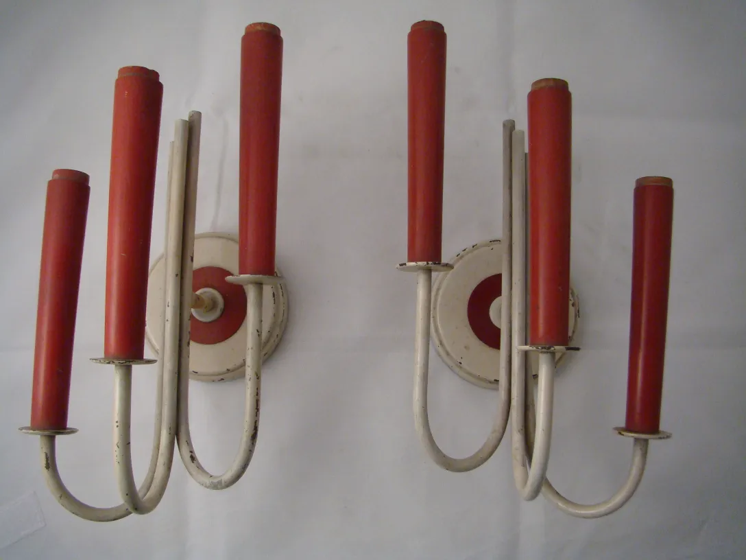Vintage sconces with red shades and an elegant design.
