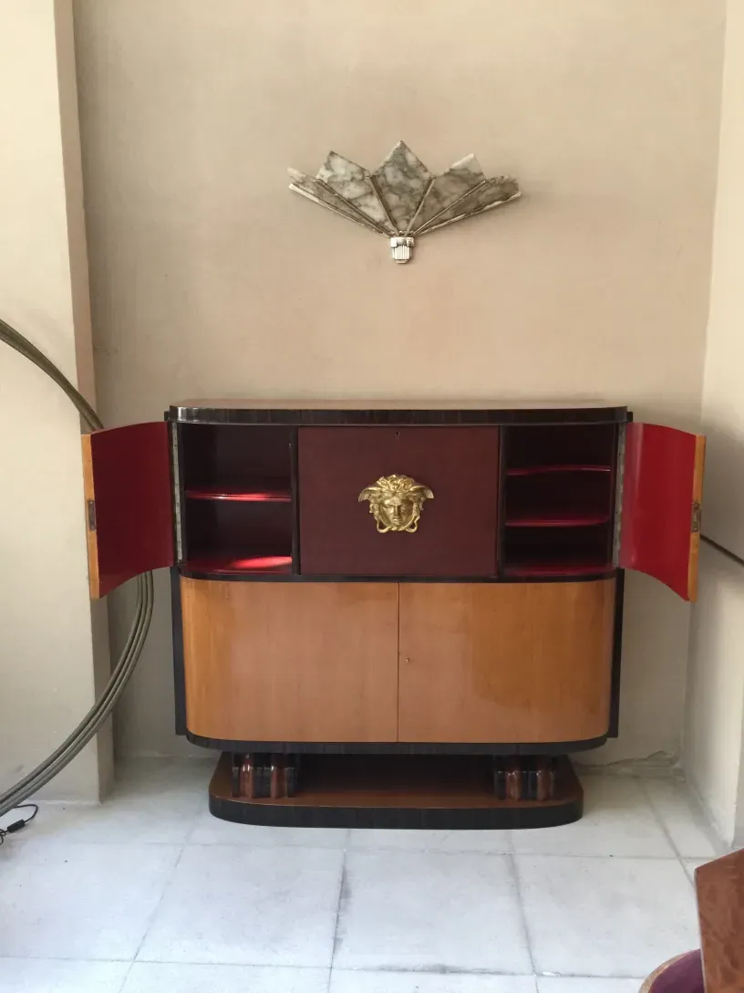 Pair of antique sconces with elegant design, beside the furniture.