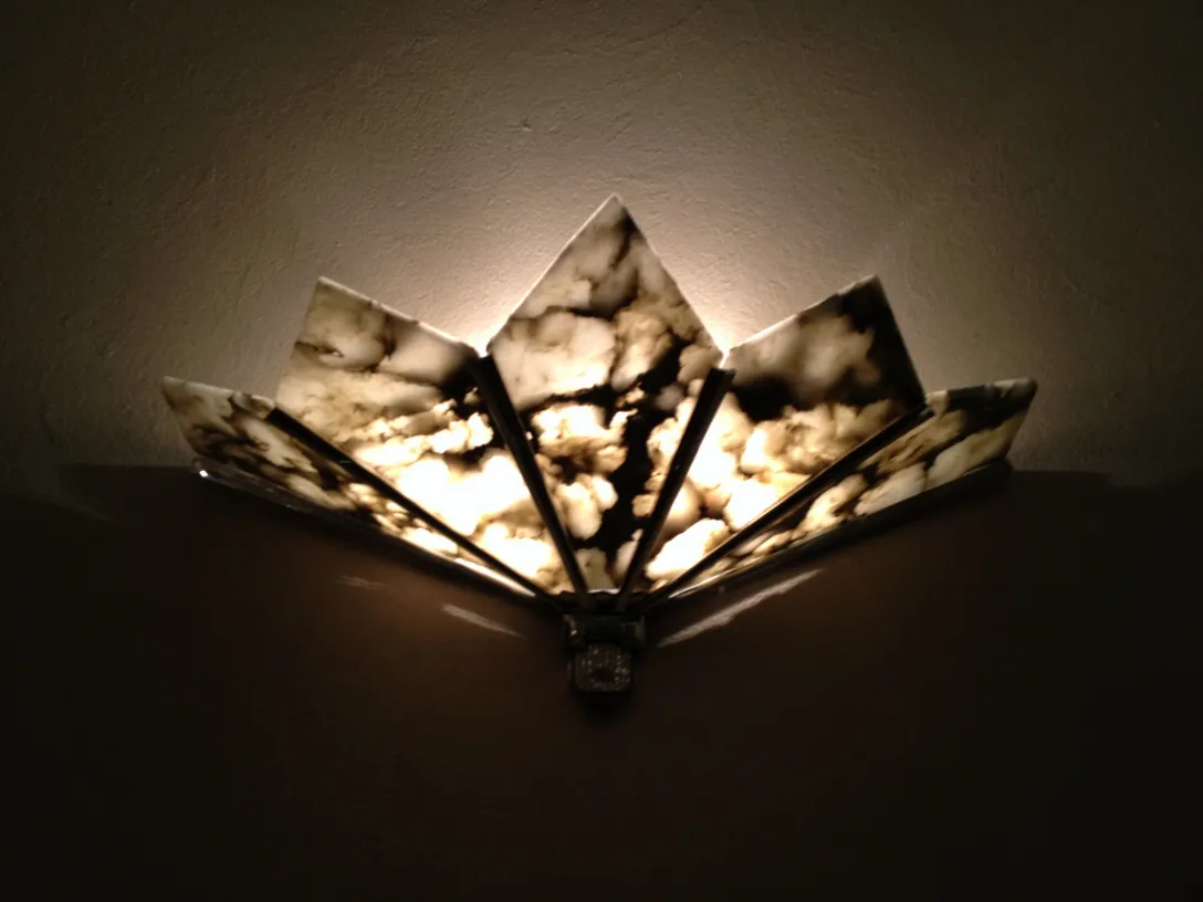 Antique pair of sconces with unique design and soft lighting, perfect for decor.