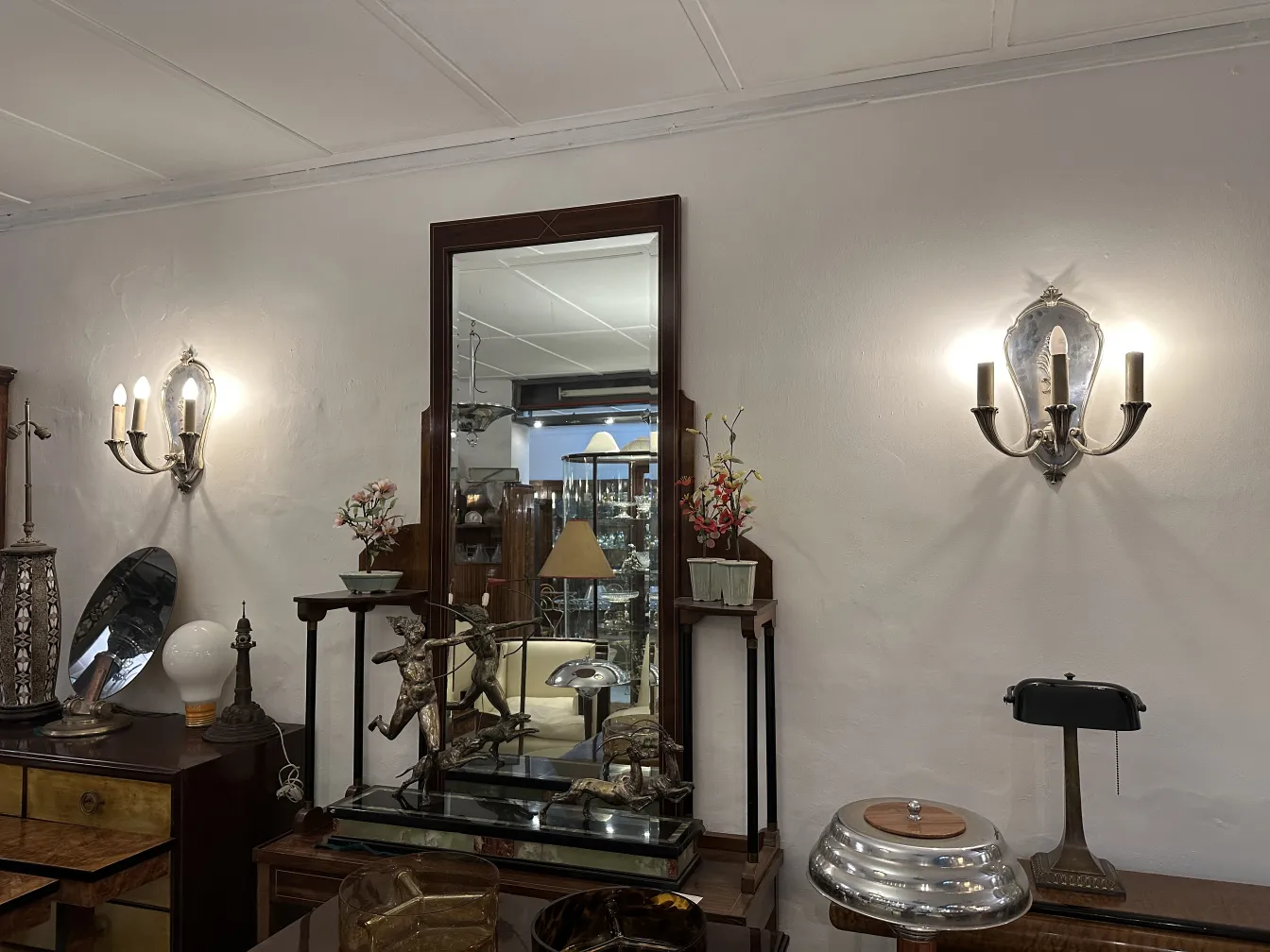 Antique sconces for wall decor, featuring decorative flowers in the background.