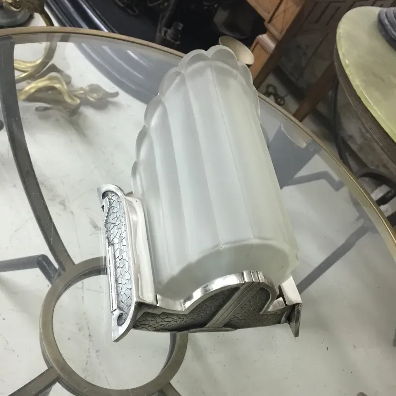 Antique wall sconces with frosted glass and metal details, ideal for decor.