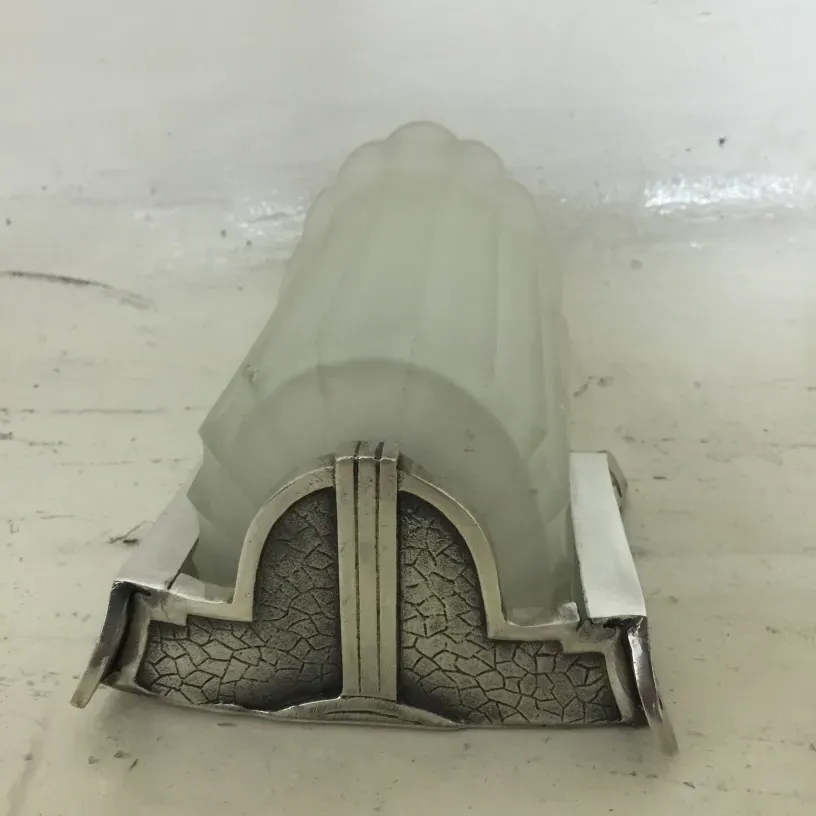 Pair of antique sconces featuring an elegant design with frosted glass.