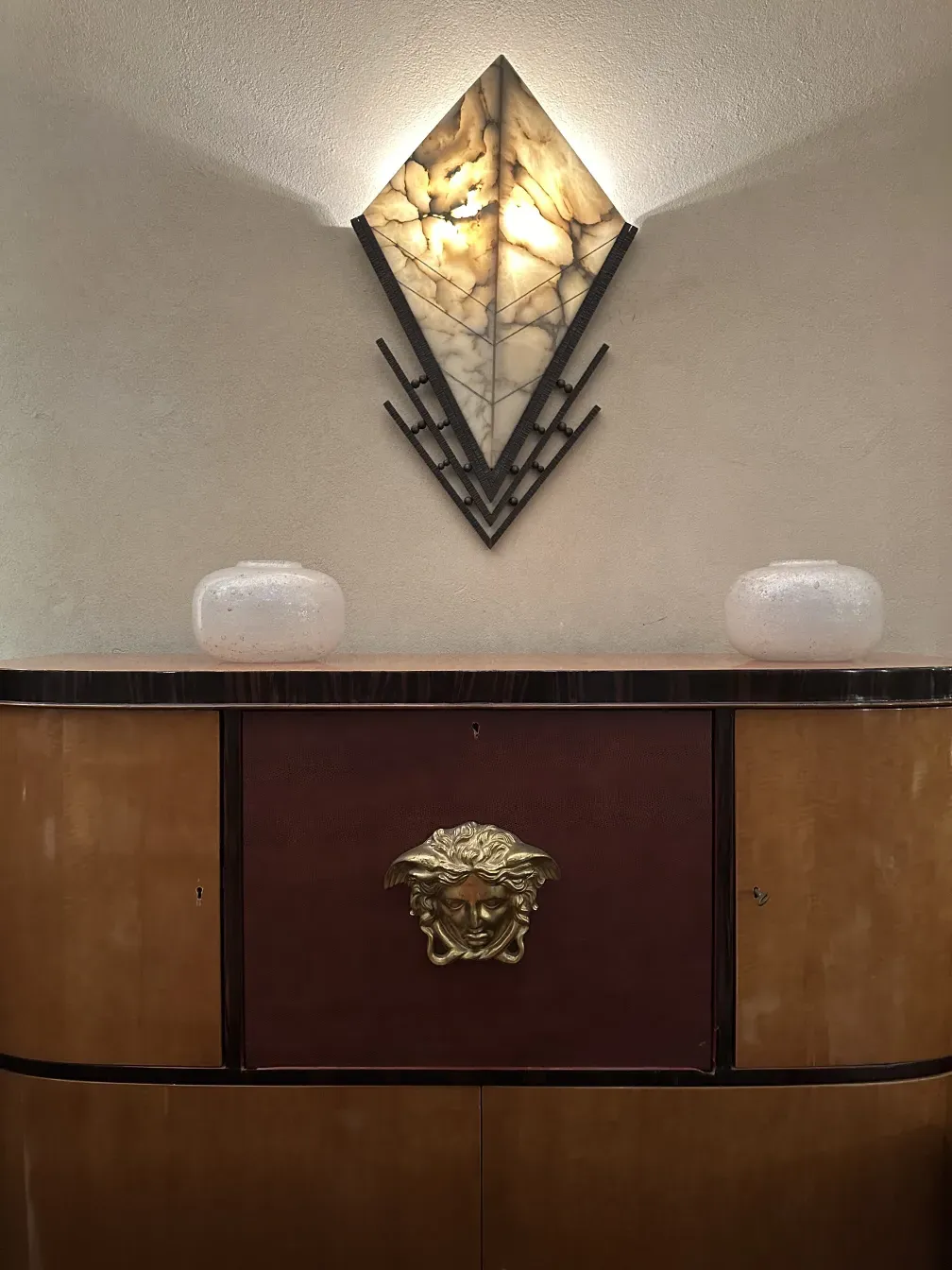 Pair of antique sconces with elegant design and warm light. Creates a cozy atmosphere.