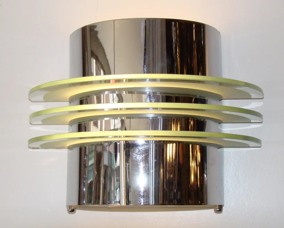 Pair of antique sconces with a modern design, featuring soft light and shiny finishes, perfect for decor.