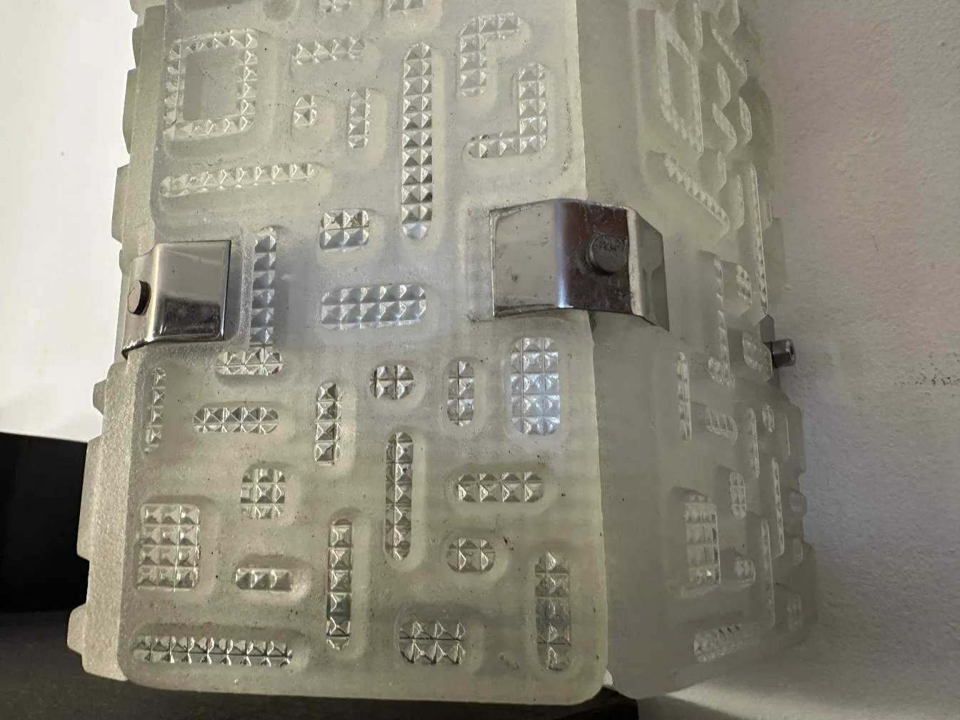 Antique sconces with unique design, white color and embossed details, soft lighting.