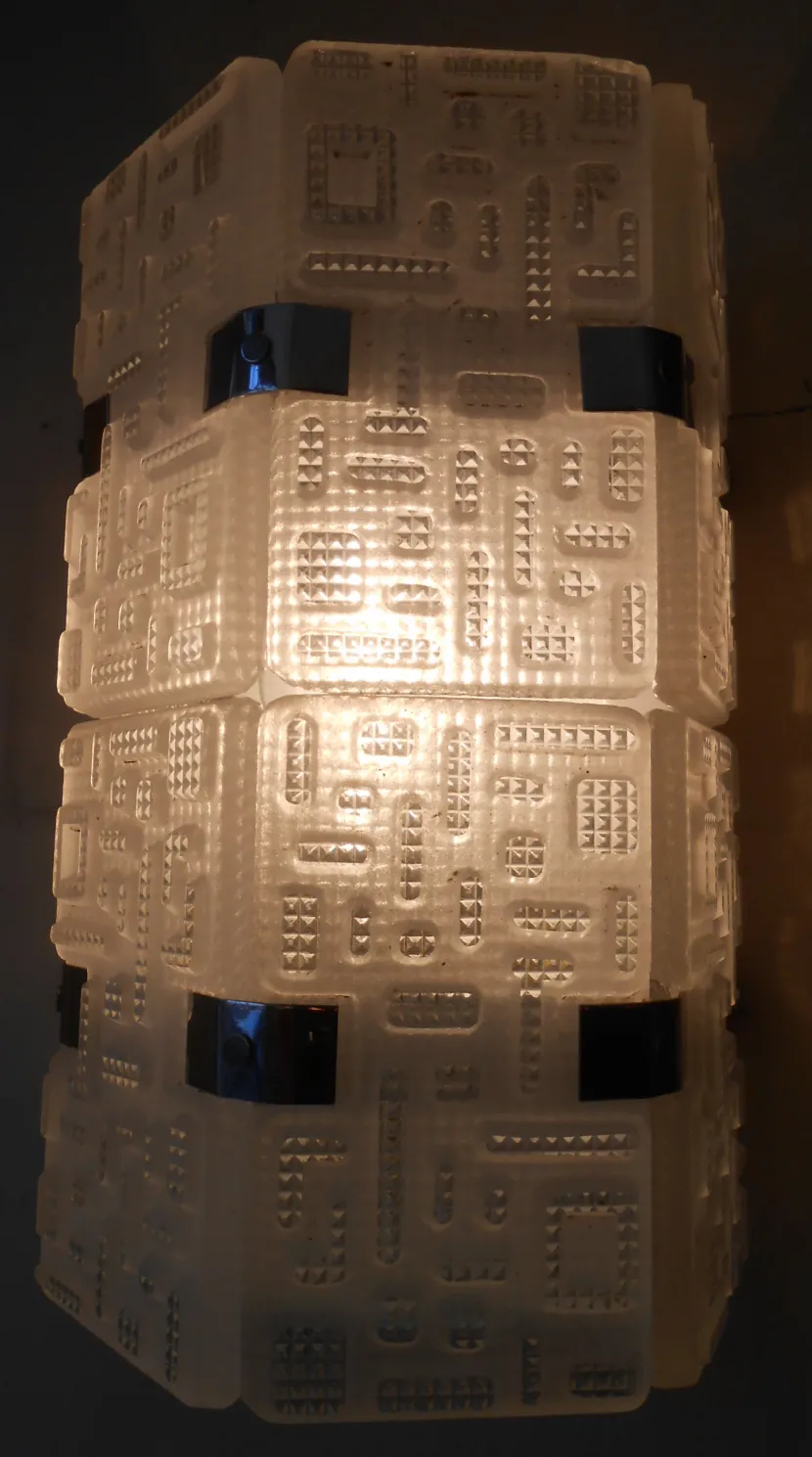 Antique pair of Orrefors sconces featuring decorative design illuminating a stylish space.