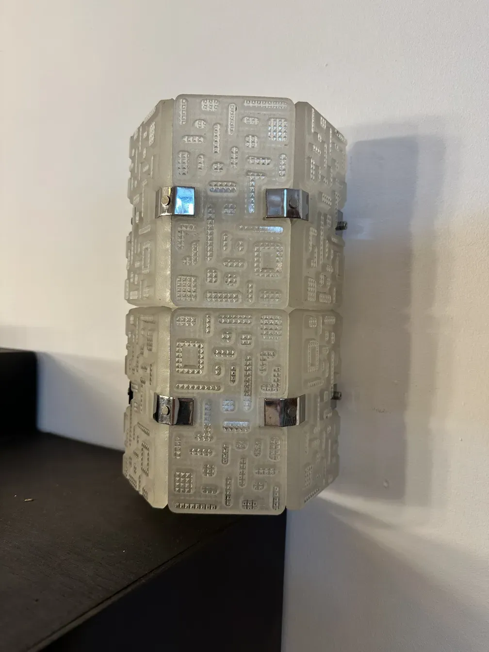 Antique pair of sconces featuring geometric design and shine, perfect for enhancing spaces, with silver details.