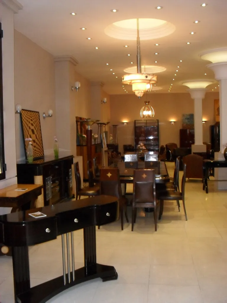 Pair of antique sconces in a showroom with furniture.