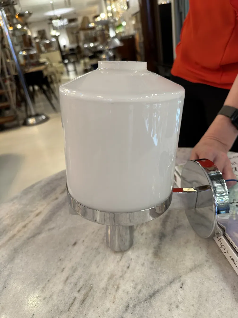 Antique pair of sconces with white glass shade and metal base, ideal for classic decor.