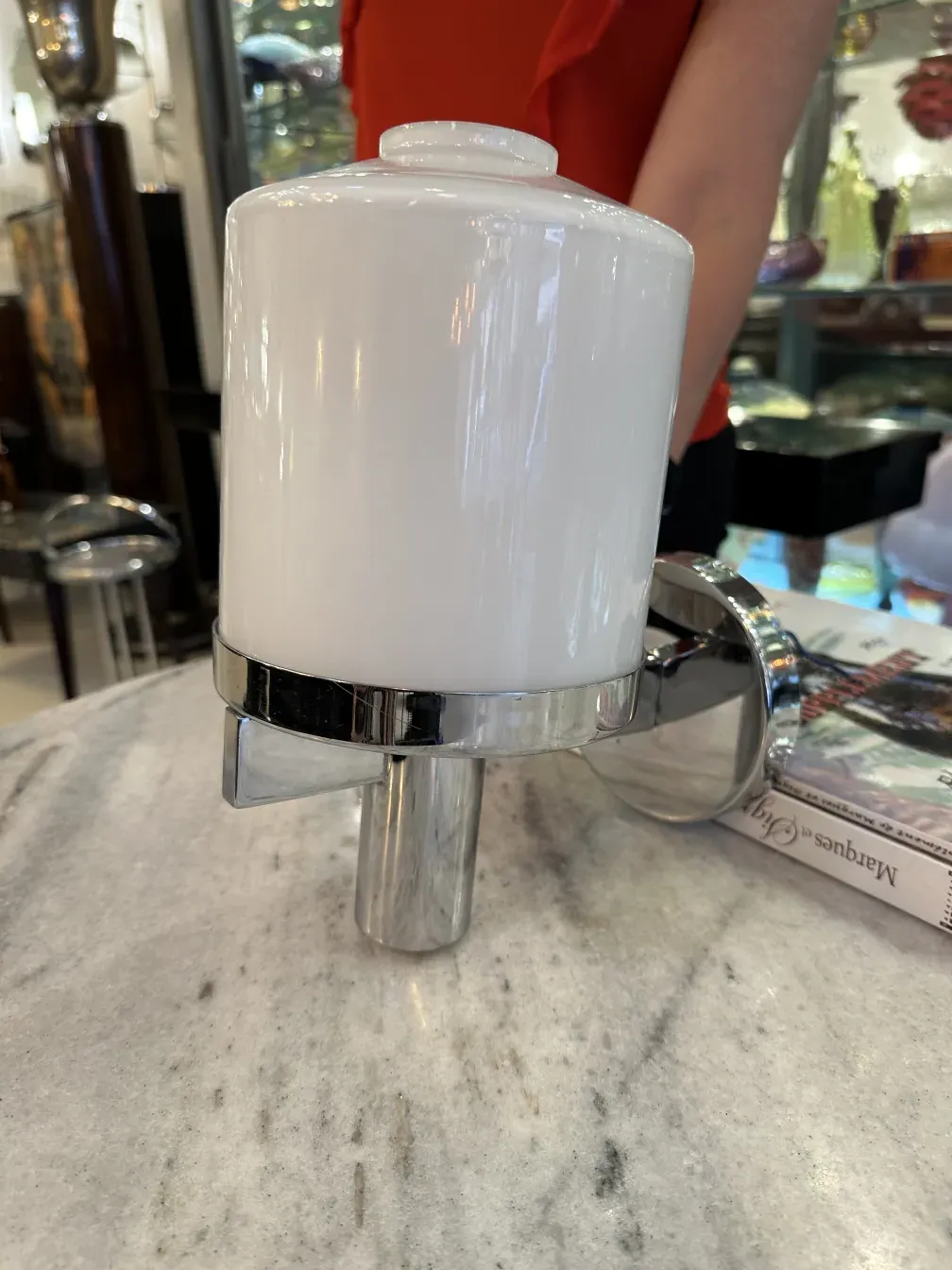 Antique sconces with an elegant design in white and chrome.