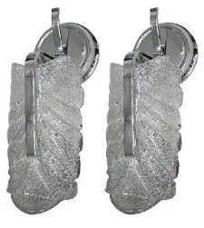 Pair of antique sconces featuring a relief design, adding elegance to a cozy space.