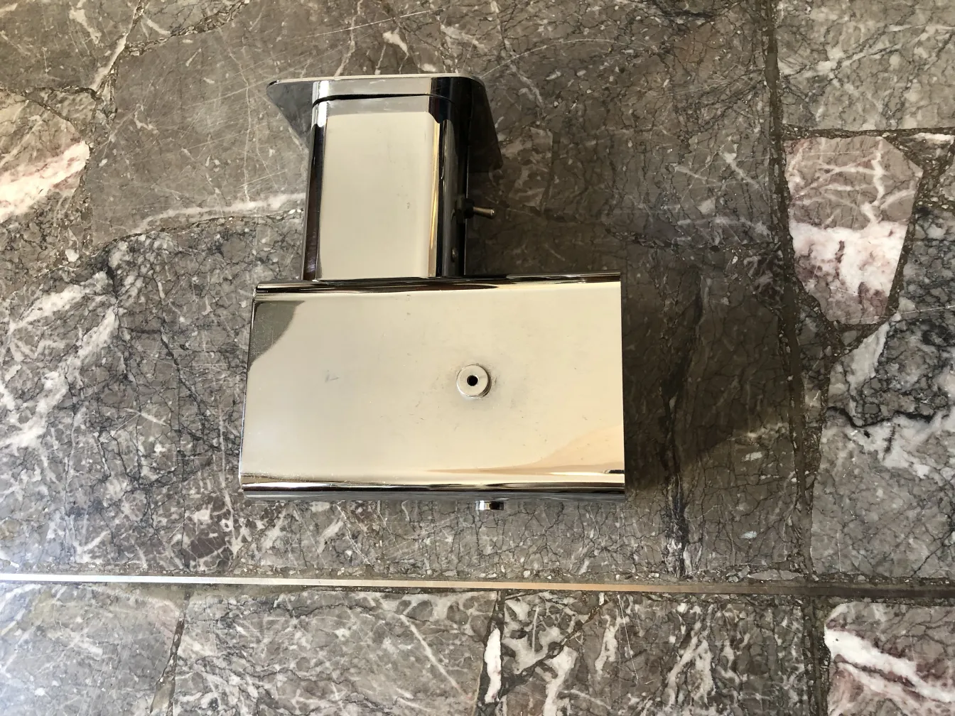 Pair of antique sconces with a shiny finish on marble.