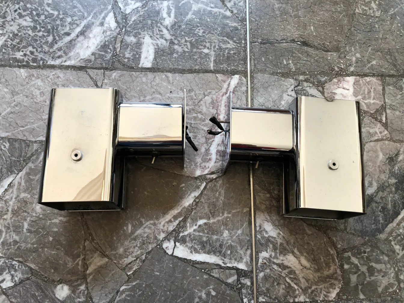 Antique sconces shining on a sleek marble surface.