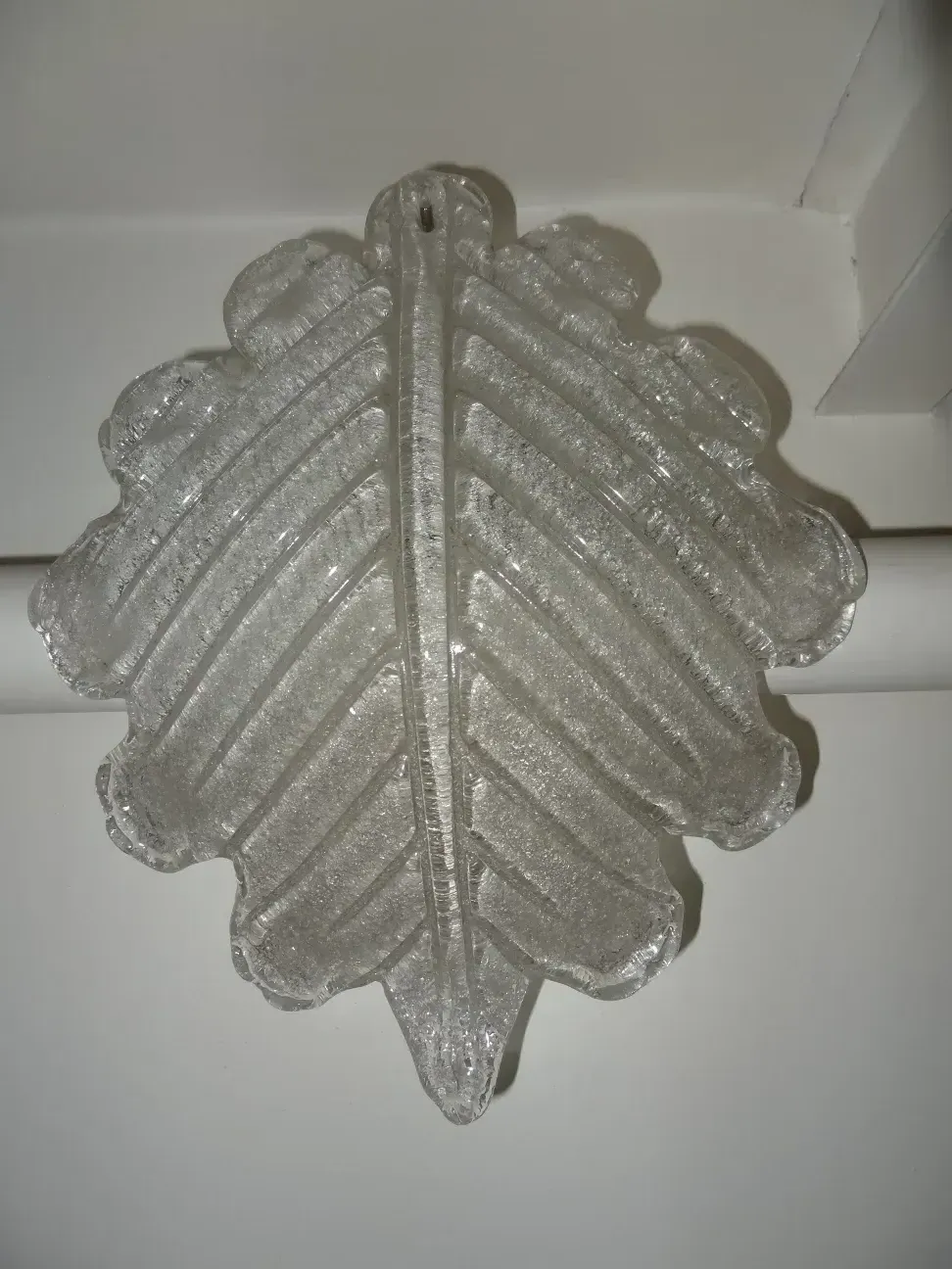 Antique leaf-shaped sconces, clear glass, decorative elements.