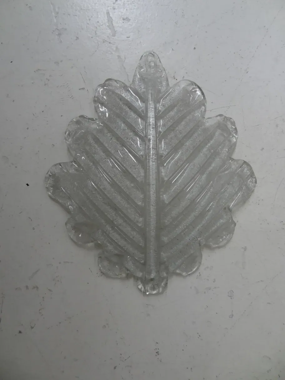 Antique pair of sconces featuring a leaf design, stylish decor.