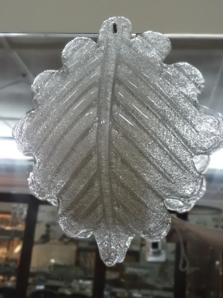 Pair of antique sconces featuring a shiny leaf design.