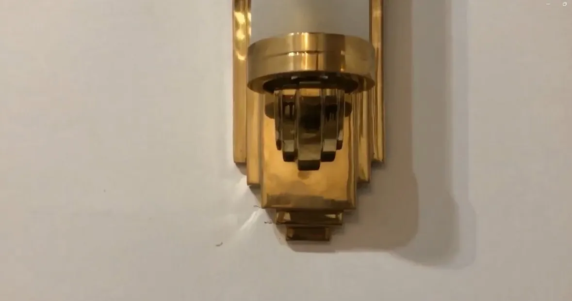 Pair of antique sconces with a golden finish, elegant and shiny, perfect for interior decor.