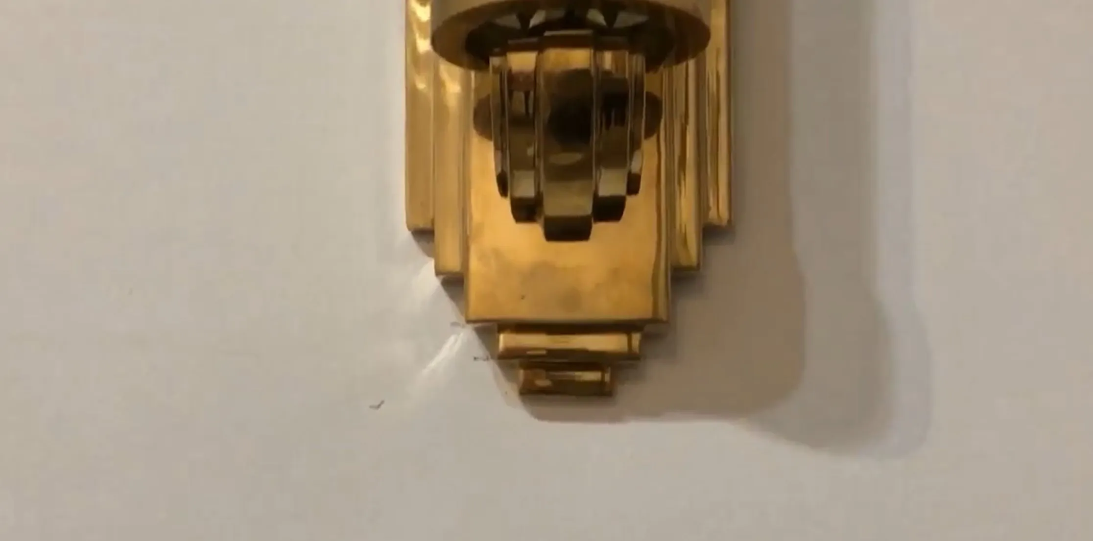 Beautiful antique pair of sconces, golden shine on the wall