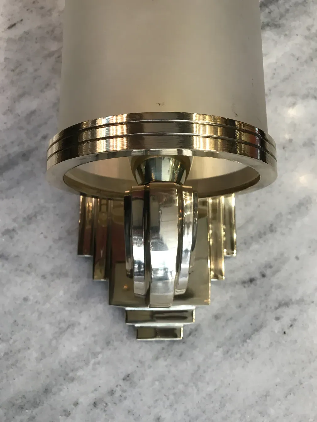 Pair of antique sconces with decorative wall design