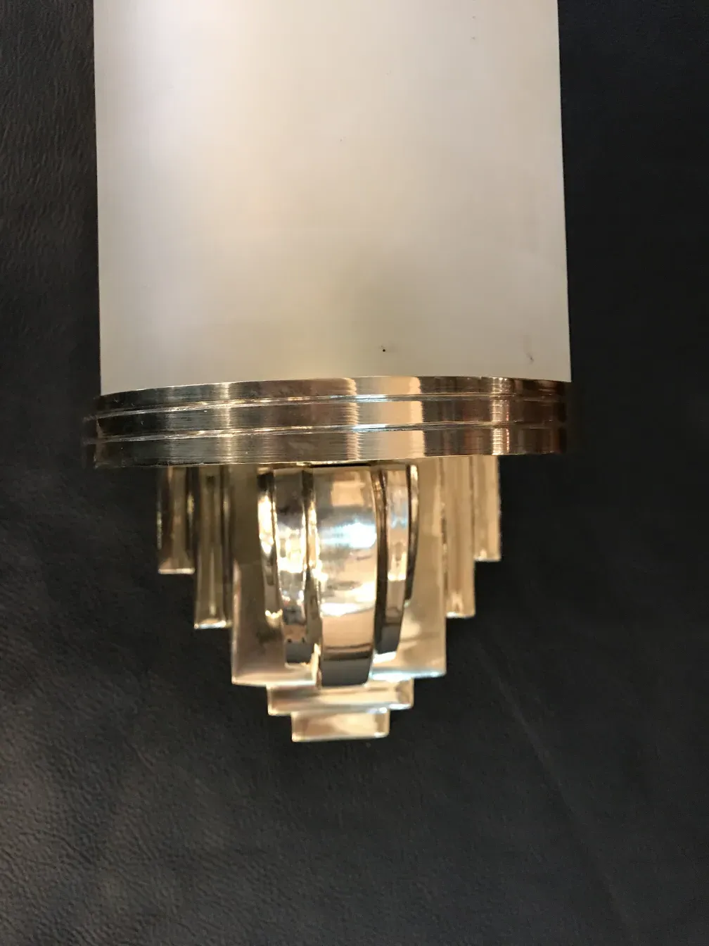 Pair of antique sconces featuring decorative details and an elegant finish.